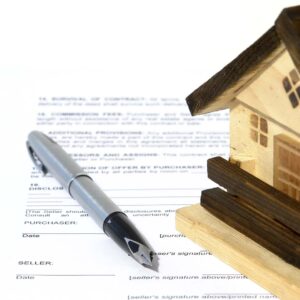 Real estate contract and house.